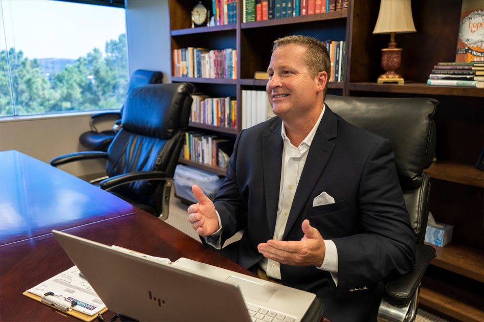 Jason talking to a client at his desk