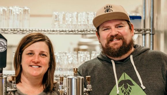 Amy and Cam Wells smiling at Arable Brewing Company