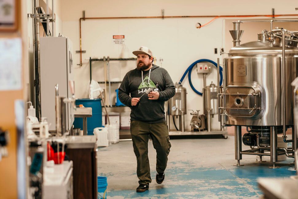 Cam Wells walking through the brewing area