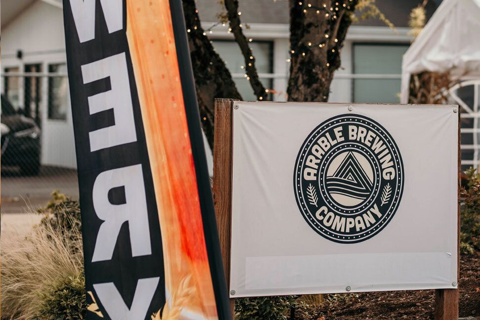 Arable Brewing Company logo on a sign in front of the business