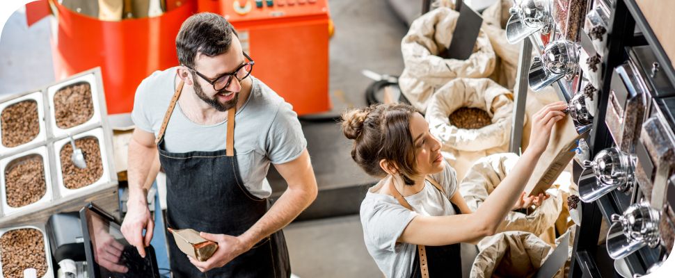 People smiling while working in a coffee shop