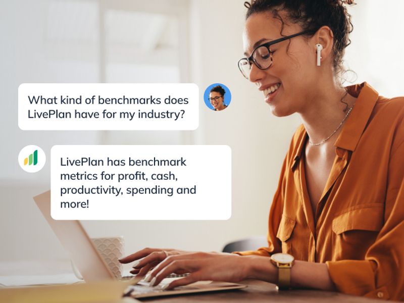 Woman smiling and working on laptop with LivePlan guidance