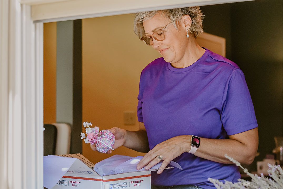 Stacie Overman packing lavender products to ship off to customers.
