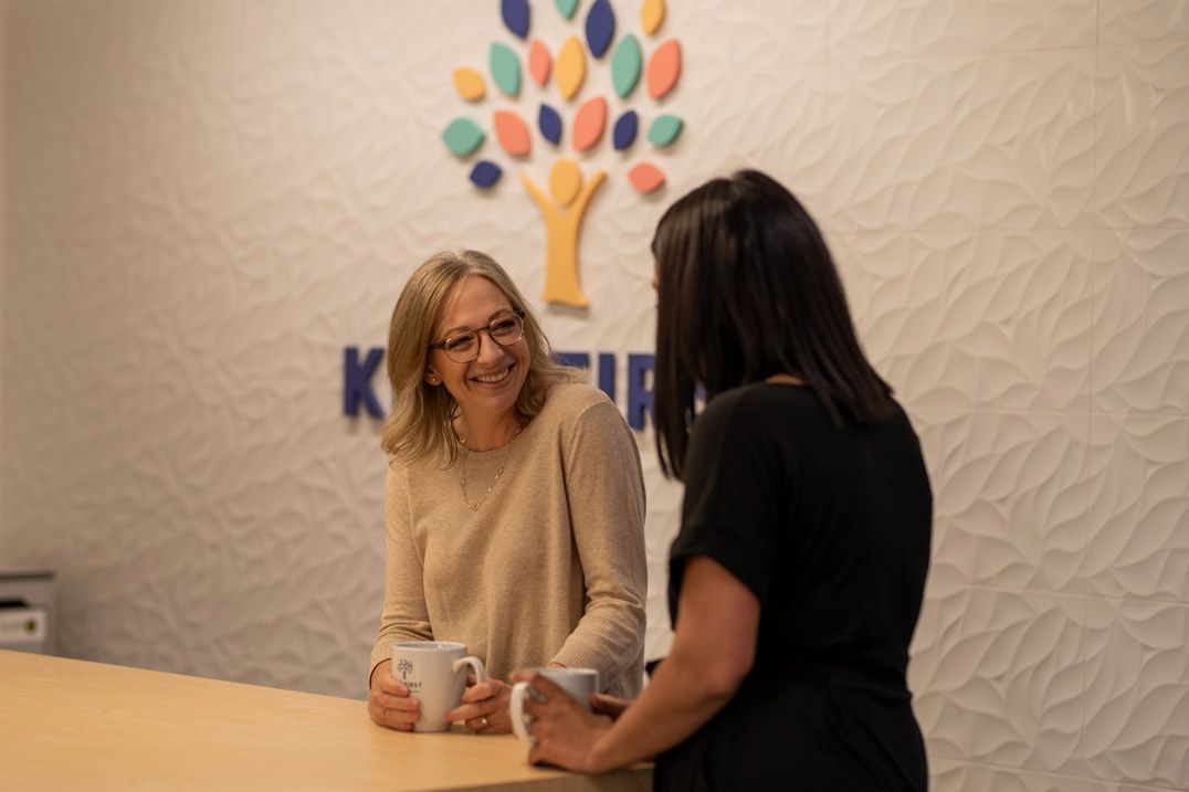 Megan and Sarah enjoy a cup of coffee, confident in the health and growth of Kids FIRST