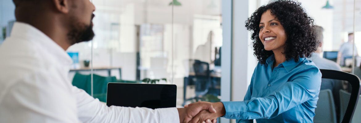 Two employees shaking hands